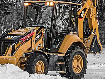 Bucket tractor picking up snow