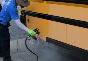 Spraying EquipCoat on a School Bus